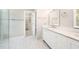 Bright bathroom with a double vanity, modern fixtures, and an adjacent walk-in closet at 3811 Cottonwood Dr, Durham, NC 27705