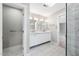 Bathroom showcasing double vanity, modern lighting, and a door to the shower room at 3811 Cottonwood Dr, Durham, NC 27705