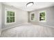 Bright, carpeted bedroom with three windows offering ample natural light at 3811 Cottonwood Dr, Durham, NC 27705