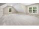 Spacious bedroom with two windows, a closet, and carpet flooring at 3811 Cottonwood Dr, Durham, NC 27705