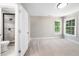 Bright bedroom featuring neutral paint, plush carpet, and natural light from double windows at 3811 Cottonwood Dr, Durham, NC 27705