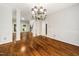 Spacious dining room featuring hardwood floors, wainscoting, and open layout to living spaces at 3811 Cottonwood Dr, Durham, NC 27705