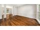 Spacious dining room featuring hardwood floors, wainscoting, elegant chandelier, and an open layout at 3811 Cottonwood Dr, Durham, NC 27705