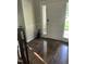 Welcoming entryway with hardwood floors, a white door, and a decorative statue at 3811 Cottonwood Dr, Durham, NC 27705