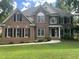 Charming brick two-story home with black shutters and manicured front lawn at 3811 Cottonwood Dr, Durham, NC 27705