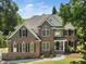 Charming two-story brick home with well-manicured lawn and mature trees providing a private setting at 3811 Cottonwood Dr, Durham, NC 27705
