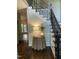 Foyer with hardwood floors, staircase, decorative table and wainscotting at 3811 Cottonwood Dr, Durham, NC 27705