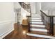Inviting foyer featuring hardwood floors, elegant staircase with iron railings, and decorative molding at 3811 Cottonwood Dr, Durham, NC 27705