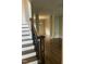 Entryway with dark hardwood floors, staircase, and columns leading into the living spaces at 3811 Cottonwood Dr, Durham, NC 27705