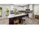 Well-lit kitchen with an island, stainless steel appliances, and tiled flooring at 3811 Cottonwood Dr, Durham, NC 27705