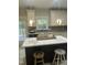 Bright kitchen featuring an island, pendant lighting, and white cabinets at 3811 Cottonwood Dr, Durham, NC 27705