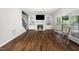 Comfortable living room featuring a fireplace, hardwood floors, and large window views at 3811 Cottonwood Dr, Durham, NC 27705