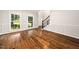 Elegant living room with hardwood floors, wainscoting, large windows, and views of the outdoors at 3811 Cottonwood Dr, Durham, NC 27705
