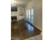 Living room with fireplace, decorative shelving, two arm chairs, and large window views at 3811 Cottonwood Dr, Durham, NC 27705