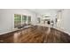 Open living space with hardwood floors and multiple windows providing natural light at 3811 Cottonwood Dr, Durham, NC 27705
