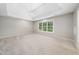 Spacious main bedroom with tray ceiling, modern chandelier, and large windows at 3811 Cottonwood Dr, Durham, NC 27705