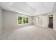 Spacious main bedroom featuring a tray ceiling, chandelier, and large windows at 3811 Cottonwood Dr, Durham, NC 27705