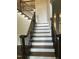 Staircase with wood treads, white risers and dark iron railing leading upstairs at 3811 Cottonwood Dr, Durham, NC 27705