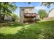 Spacious backyard featuring a two-story home with a wooden deck and lush green lawn at 401 Holly Thorn Trce, Holly Springs, NC 27540