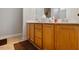 Bathroom featuring a double sink vanity with oak cabinets and cultured marble countertop at 401 Holly Thorn Trce, Holly Springs, NC 27540
