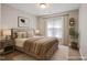 Inviting bedroom with neutral walls, wood furnishings, soft natural light, and decorative plants at 401 Holly Thorn Trce, Holly Springs, NC 27540