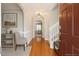 Inviting foyer with hardwood floors, neutral walls, staircase, and decorative archway for a bright and airy feel at 401 Holly Thorn Trce, Holly Springs, NC 27540
