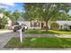 Quaint home featuring manicured lawn, dark red shutters, and an inviting front entrance and a front facing garage at 401 Holly Thorn Trce, Holly Springs, NC 27540