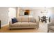 Bright living space featuring a neutral-toned sofa, dining table, and carpet that creates an inviting and open atmosphere at 401 Holly Thorn Trce, Holly Springs, NC 27540