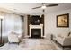 Comfortable living room with a decorative fireplace, large TV, and neutral-colored furnishings creating a relaxing space at 401 Holly Thorn Trce, Holly Springs, NC 27540