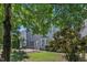 Exterior view of a home with a brick patio, arbor, lush grass and landscaping at 413 Westfalen Dr, Cary, NC 27519