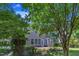 Brick patio with landscaping and mature trees provides a private area for outdoor living and entertaining at 413 Westfalen Dr, Cary, NC 27519
