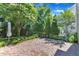 Brick patio with arbor, landscaping, and mature trees provides privacy and a serene atmosphere at 413 Westfalen Dr, Cary, NC 27519