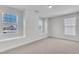 A bedroom with carpet, neutral paint, white trim, three windows, and two window seats at 413 Westfalen Dr, Cary, NC 27519