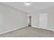 Neutral bedroom with carpet, white trim, doorway into hallway, and a closet on the left at 413 Westfalen Dr, Cary, NC 27519