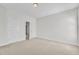 Bright bedroom with carpet, neutral paint, white trim, and a doorway into the hallway at 413 Westfalen Dr, Cary, NC 27519