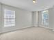 Spacious bedroom with carpet, natural light from two windows, and neutral paint color at 413 Westfalen Dr, Cary, NC 27519
