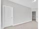 A bedroom with neutral paint, carpet, white trim, and view into the hall and stairway at 413 Westfalen Dr, Cary, NC 27519