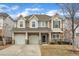 Beautiful two-story home featuring a two-car garage, stone accents, and a well-manicured front yard at 413 Westfalen Dr, Cary, NC 27519