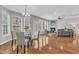 Open concept dining area and living room with hardwood floors, a fireplace, and lots of natural light at 413 Westfalen Dr, Cary, NC 27519