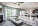 Inviting living room featuring a fireplace, large windows, and stylish decor at 414 Grange Farm Pl, Raleigh, NC 27603