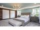 Serene main bedroom suite with a king-size bed, a stylish chandelier, and a peaceful ambiance at 414 Grange Farm Pl, Raleigh, NC 27603