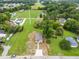 Aerial view showcasing the property's placement with neighboring homes and the expansive greenspace around it at 414 S Center St, Princeton, NC 27569