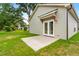 Newly constructed home with a concrete patio and double doors that lead to the backyard and lawn at 414 S Center St, Princeton, NC 27569