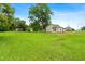 Expansive green backyard showcasing the home's generous lot size and views of mature trees at 414 S Center St, Princeton, NC 27569