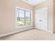 Bedroom with large window, neutral carpet, and closet at 414 S Center St, Princeton, NC 27569
