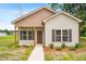 Charming home featuring a well-manicured lawn and inviting entrance at 414 S Center St, Princeton, NC 27569