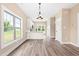 Modern kitchen with white cabinets and sleek appliances open to the living room at 414 S Center St, Princeton, NC 27569