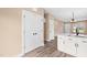 Bright kitchen with pantry, white cabinets, quartz countertops, and open to dining area at 414 S Center St, Princeton, NC 27569