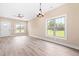 Bright open floor plan with large windows and laminate flooring at 414 S Center St, Princeton, NC 27569