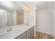 Bright bathroom featuring double sink vanity, a large mirror, and neutral color palette at 44 Chloe Ct, Selma, NC 27576